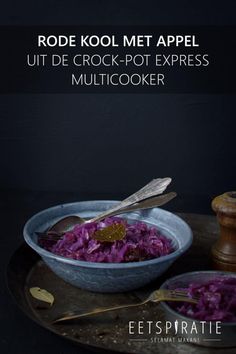 a bowl filled with red cabbage next to a spoon