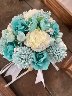 a bridal bouquet with blue and white flowers