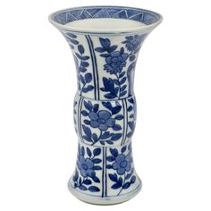 a blue and white vase with flowers on it