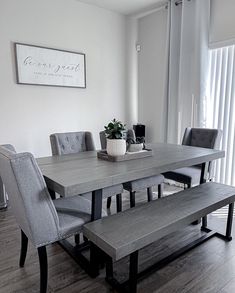 a dining room table with benches in front of it