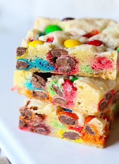 three pieces of cookie bars stacked on top of each other with candy and m & ms