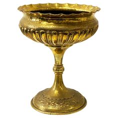 an ornate gold vase is shown against a white background for use as a centerpiece