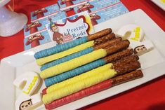 there is a plate with bananas and other food items on it, including pretzel rods