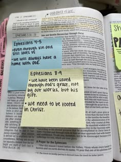 an open bible with sticky notes attached to the pages that have been placed on it