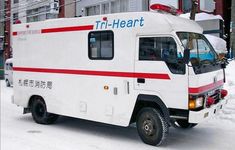 an ambulance is parked on the side of the road in the snow, with it's doors open