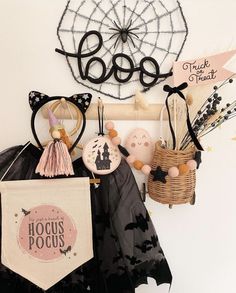 there are many items hanging on the wall and in front of it is a sign that says hocus pocus