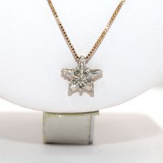 "Say \"You Are My Star\" with this 10K yellow and white gold and diamond pendant. Includes a 20 inch 14K white gold chain! Pendant stamped \"10K\". Chain stamped \"14K\". The perfect gift for your anniversary, a wonderful grooms gift for the new bride or a wonderful addition to your personal jewelry collection. FREE SHIPPING! Details: 10K White Gold: (as shown in picture) Natural Diamond: (1) 1 mm round, (5) 1.15 mm round Approximate Diamond Weight: .0385 carats Diamond Clarity: SI Diamond Color White Star-shaped Diamond Jewelry, White Star-shaped Formal Jewelry, Star-shaped Diamond Necklace With Accents For Anniversary, Star-shaped Diamond White Necklace For Anniversary, Star Shaped Diamond Necklace For Anniversary, White Star-shaped Jewelry With Brilliant Cut, Anniversary Star Shaped Diamond Necklace, Star-shaped Diamond Necklace For Anniversary, Fine Jewelry Star-shaped Diamond Necklace For Anniversary