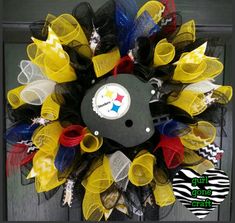 a yellow, black and red mesh wreath with the pittsburgh lions on it