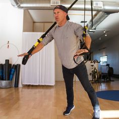 a man is doing aerial exercises in the gym