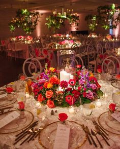 the centerpiece is surrounded by flowers and candles