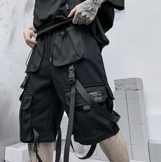 Master the concrete Jungle with our techwear shorts: when style meets performance. Discover our new streetwear shorts – the epitome of city-life fashion. Merging the thrilling world of tech clothing with the convenience of everyday apparel, these shorts reflect a unique symphony of style and function. Designed for the modern urbanite, these black techwear shorts features multiple front pockets, buckles, and straps, adding rich texture and a sophisticated tactical aura to your outfit, guaranteed to attract attention and keep rivals at bay. On a balmy summer night, when the city calls you to roam its shadowy streets, our shorts promise comfort and an unforgettable cyber ninja style. Wave goodbye to the day's stifling heat and embrace the cool, nocturnal breeze. The city streets are your runw Pastel Techwear, Punk Shorts, Harajuku Punk, Tech Wear, Streetwear For Men, Streetwear Shorts, Knee Length Shorts, Estilo Hip Hop, Cargo Shorts Men