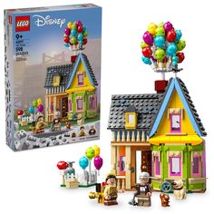 the lego disney house has balloons on it's roof and is next to its box