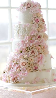 a wedding cake with pink flowers on it