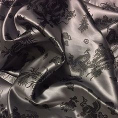 an image of a black and white fabric with animals on it's back side