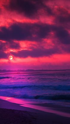 the sun is setting over the ocean with purple clouds