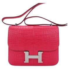 Mightychic offers an Hermes 18 Constance in richly saturated Rose Extreme Matte Alligator. All grown up pink that is like a jewel in your hand. Accentuated with Palladium hardware. The effect is understated and fresh. Hermes Paris Made in France is stamped on front under flap. Comes with Hermes sleeper and orange signature box. NEW or NEVER WORN. final sale BAG MEASURES: LENGTH 7.5" TALL 5.5" DEEP 2" STRAP: SINGLE 22" DOUBLE 12" CONDITION: NEW or NEVER WORN Mini Constance, Hermes Constance Bag, Vintage Crossbody Bag, Hermes Constance, Elegant Bags, Jane Birkin, Hermes Paris, All Grown Up, Iconic Bags