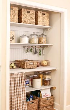 an organized pantry with baskets, food and other items on the shelve shelves