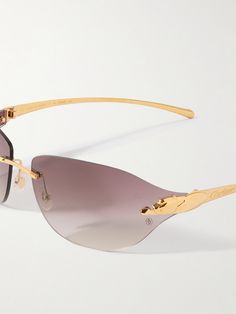 Cartier Eyewear's rimless sunglasses are accented with the iconic 'Panthère' motif along the temples. They're made from polished gold-tone metal and fitted with gradient lenses that recall classic '00s styles. 00s Style, Tom Ford Bag, New Bottega, Rimless Sunglasses, Eyewear Womens, Sunglasses For Men, Gold Sunglasses, Fine Jewelry Designers, Eyewear Accessories