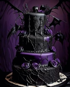 a three tiered cake decorated with black and purple icing, bats and roses