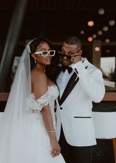 a bride and groom posing for the camera