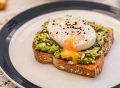 an egg on toast with avocado and almonds