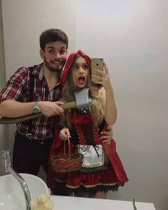 a man taking a selfie with a woman dressed as a little red riding hood