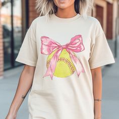 Get this Coquette Softball tee and be the belle of the ballpark!  Each shirt is printed in-house by me using high-quality materials on a Comfort Colors shirt, known for its exceptional comfort, style, and durability. Available in unisex sizes S to 3X, and youth sizes, we've got you covered regardless of your preferred fit. This Baseball/Softball Shirt features a classic crew neck and short sleeves, making it suitable for year-round wear. The flattering silhouette ensures a comfortable and stylis Pink Graphic T-shirt For Baseball Season, Pink Graphic Print T-shirt For Baseball Season, Spring Team Spirit Short Sleeve T-shirt, Spring Short Sleeve T-shirt With Team Spirit, Spring Graphic Print T-shirt For Sports Events, Softball Tees, Softball Shirt, Bulldog Shirt, Comfort Colors Shirt