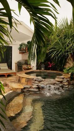 an outdoor hot tub surrounded by palm trees