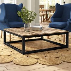 a living room with two blue chairs and a coffee table