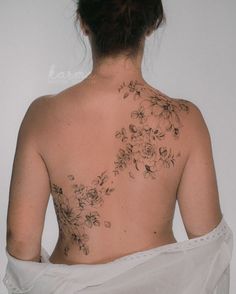 the back of a woman's body with flowers on it