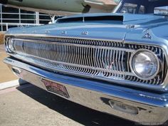 the front end of an old blue car