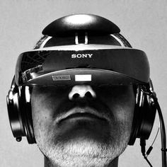 a man with headphones on his ears and wearing a headset that says sony