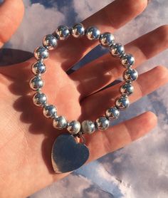 This is a super cute silver beaded bracelet with a heart charm from the early 2000s. It's made with Elastic so it's stretchy. Silver Beaded Bracelet, Silver Heart Bracelet, The Early 2000s, Silver Bead Bracelet, Heart Bracelet, Early 2000s, Silver Heart, A Heart, Heart Charm