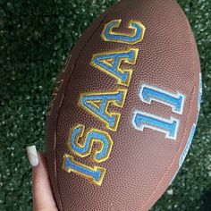 a close up of a person holding a football