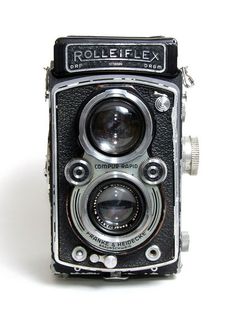 an old fashioned camera sitting on top of a table