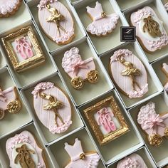 a box filled with lots of decorated cookies in pink and gold designs on top of each other