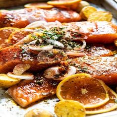 salmon with onions and lemons on a platter