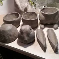 some clay animals and bowls on a table