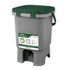 a grey and green plastic trash can