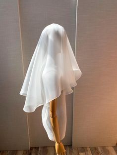 a mannequin wearing a white dress and veil