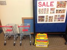 two shopping carts sitting next to each other in front of a sale sign on the wall