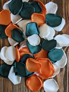 several different colored pieces of fabric sitting on top of a wooden table