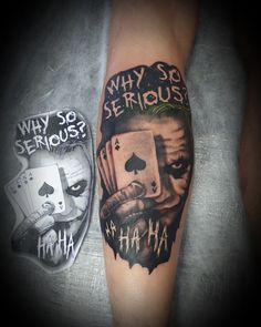 a joker tattoo on the arm with an image of a man's face and playing cards