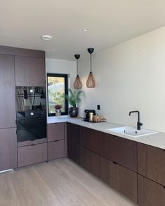 a kitchen with wooden cabinets and white counter tops