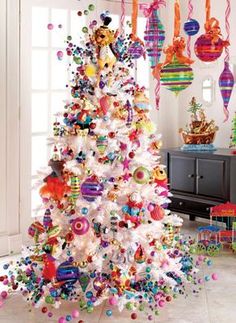 a white christmas tree decorated with colorful ornaments