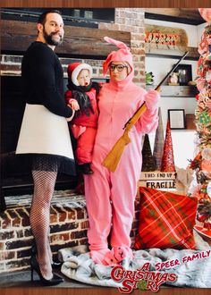 the man and woman are dressed up as santa claus, with their child in costume