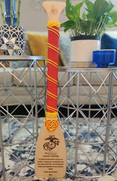 a wooden paddle sitting on top of a table next to a potted plant in a living room