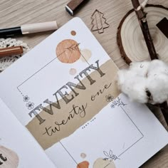 an open notebook with the words twenty twenty one written on it next to some crafting supplies