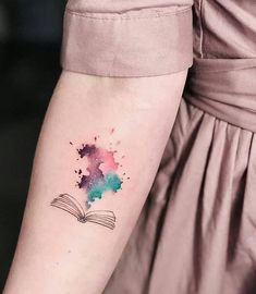 a woman's arm with a book tattoo on the left side of her arm