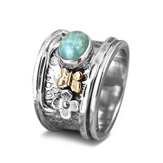 Fidget ring with Amazonite stone. Inspired by nature with cute flower and butterfly. Made of sterling silver, gold brass and genuine gemstone.*Our jewelry features natural, genuine gemstones, ensuring each piece is unique and one-of-a-kind. Please note that, as no two gemstones are identical, the jewelry you receive may vary from the photos.For wide-band rings, we recommend sizing up for the best fit.Material: Genuine Sterling Silver 92.5 Gemstone: Amazonite Gemstone size: 6x7mm Ring size: Choos Bohemian Butterfly Ring For Gift, Butterfly Gemstone Ring For Gift, Gemstone Butterfly Jewelry For Anniversary, Butterfly Gemstone Jewelry For Anniversary, Butterfly-shaped Gemstone Jewelry For Anniversary, Unique Turquoise Ring With Gemstone Accents, Unique Turquoise Ring With Gemstone Accents As Gift, Bohemian Gemstone Flower Ring As Gift, Flower And Butterfly